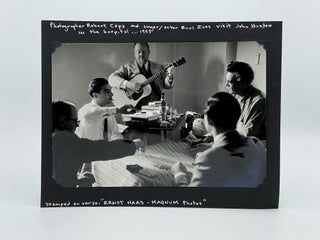 Item #406043 Photograph of Robert Capa and Burl Ives visiting John Huston in the hospital, 1953....